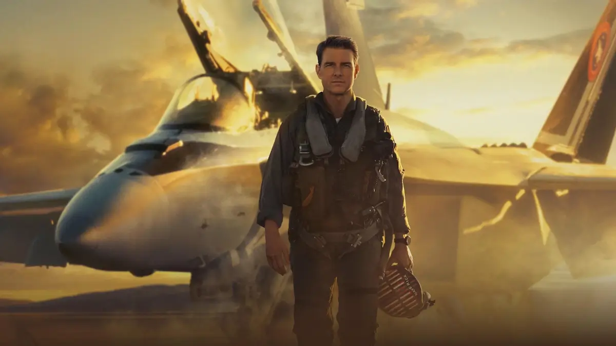 Tom Cruise as Maverick in a flight suit standing in front of an F/A-18 fighter jet, Top Gun 3
